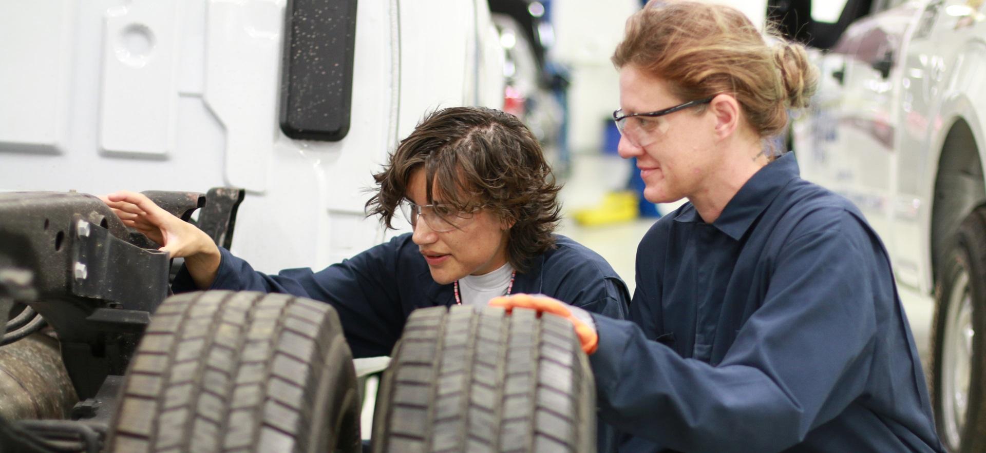 Motive Power students looking at vehicle tires