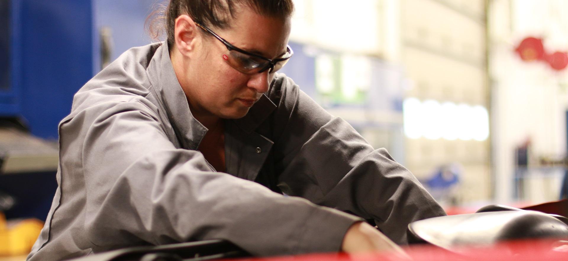 Motive Power student working under the hood of a vehicle