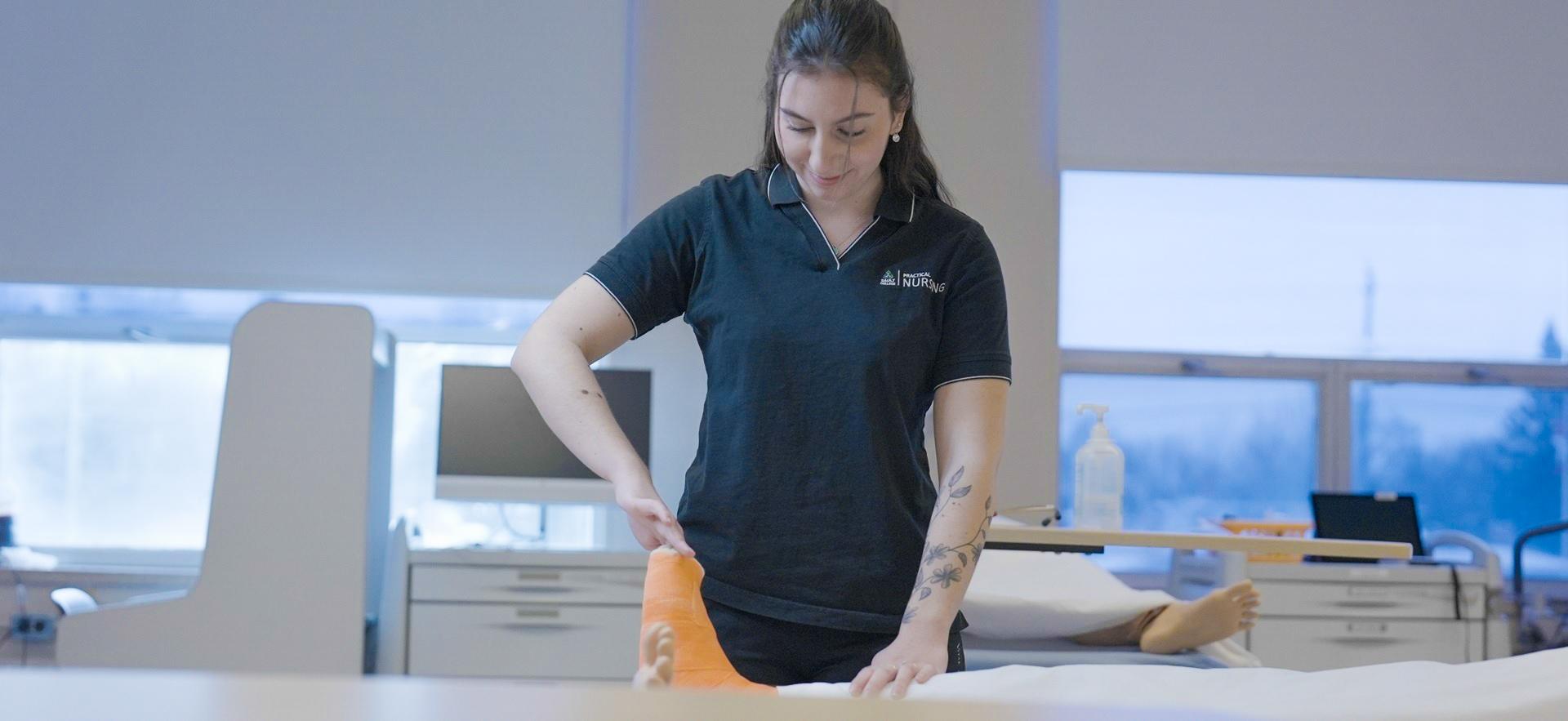 Nursing student assessing casted foot on sim