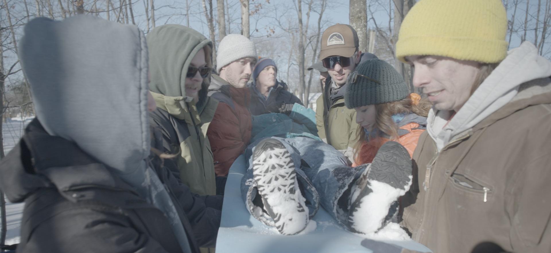 SONE students carrying classmate out for practicing wilderness first aid