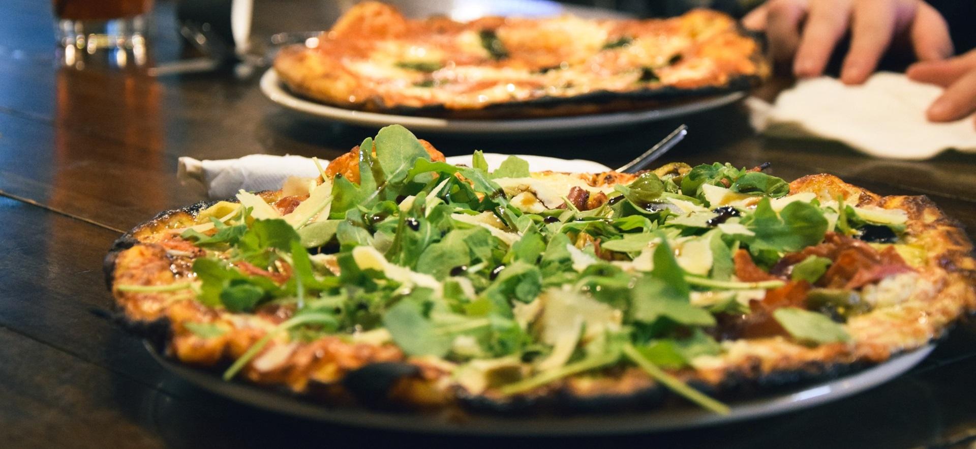 Pizza and drinks on table at Boiler Room