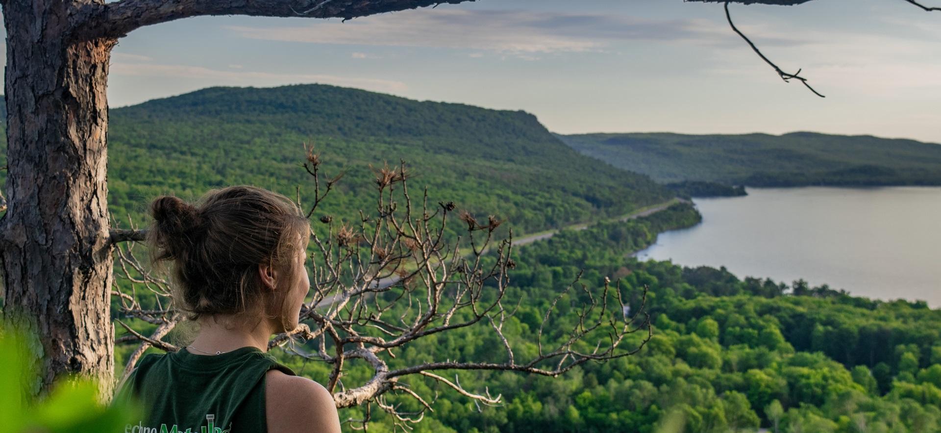Girl looking out over cliff at Eagles Nest