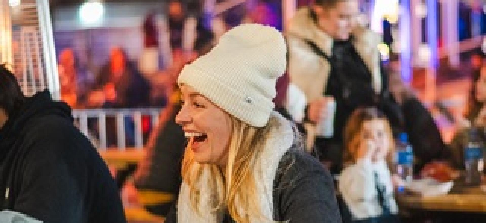 People sitting at tables outside in winter at event