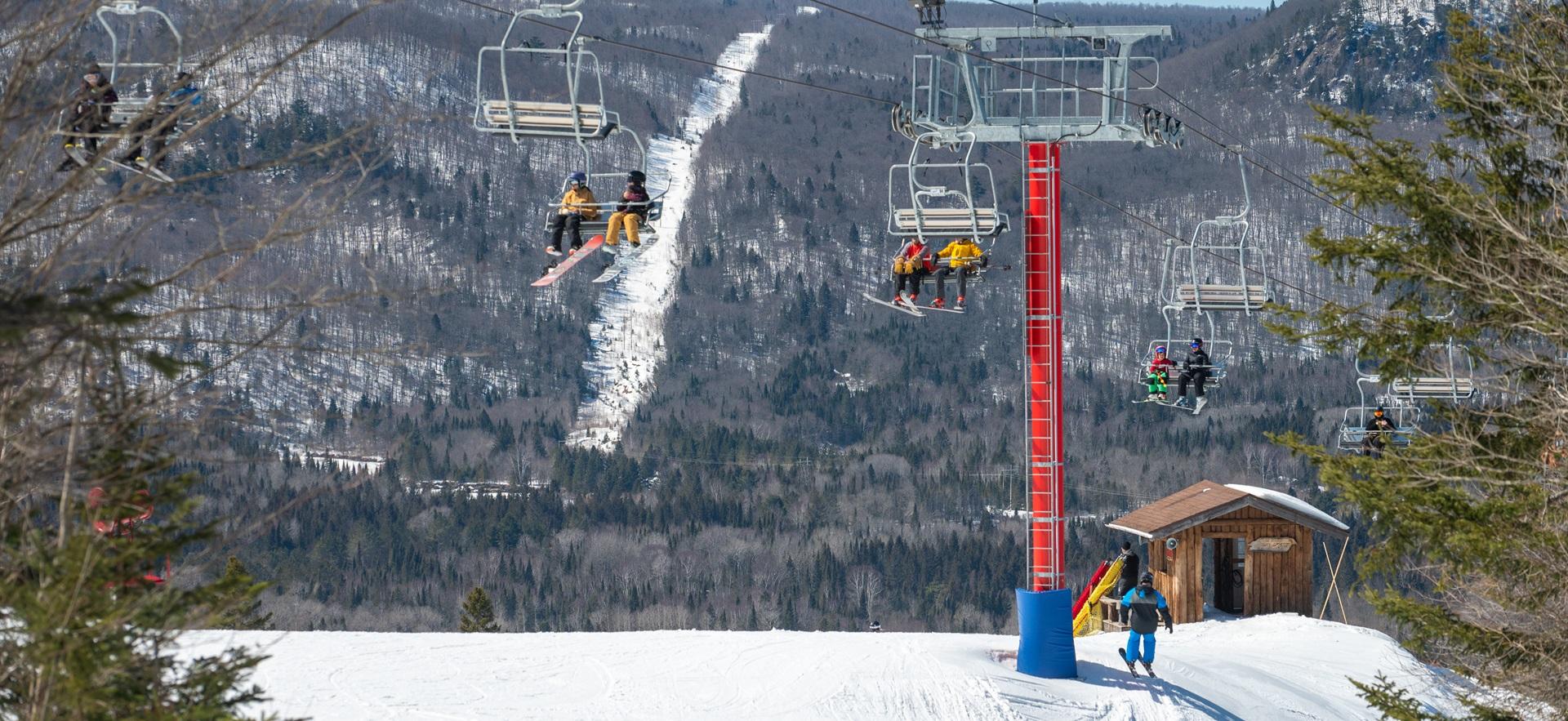 Searchmont Resort on a clear day showing people on ski lifts