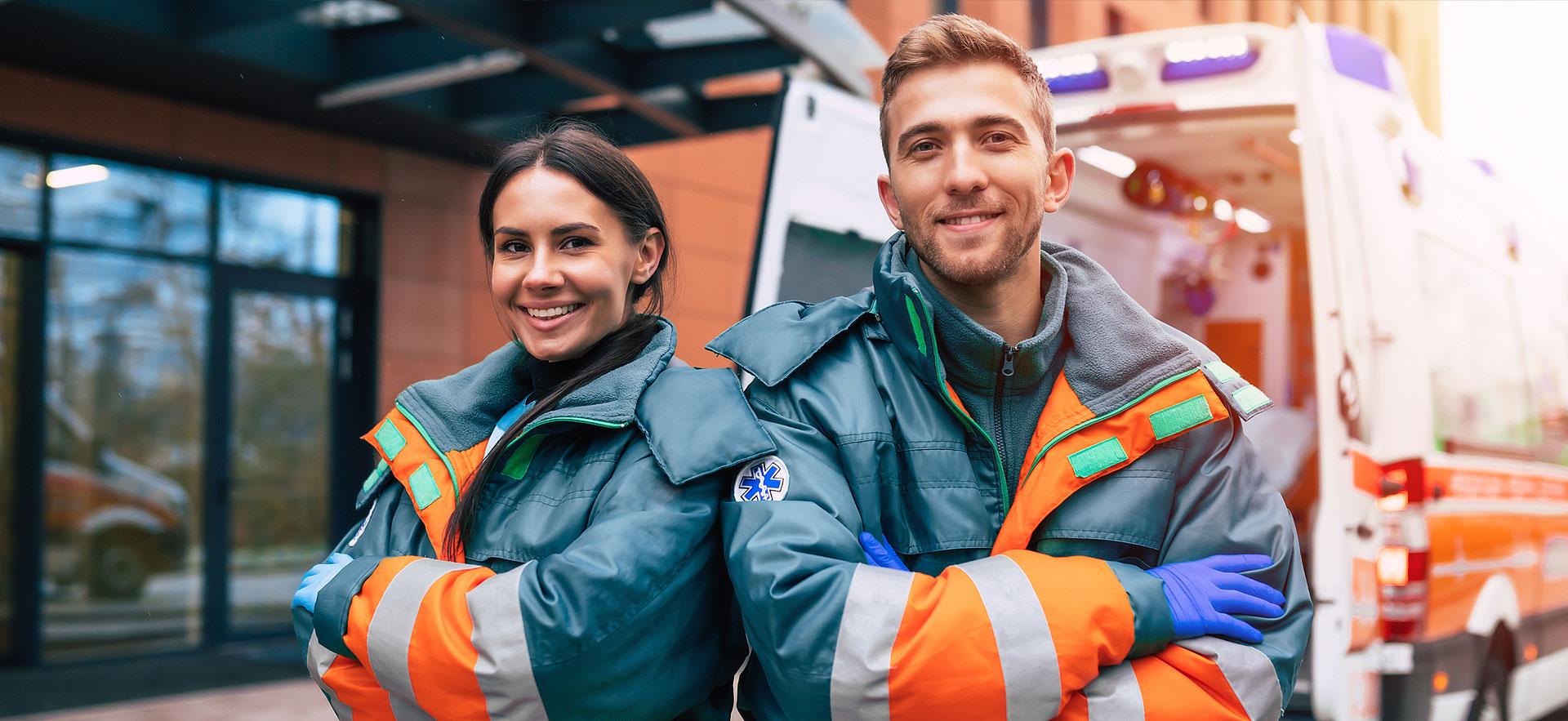 Image of two paramedics standing in front of ambulance