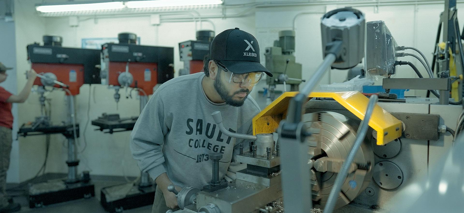 male student at a lathe 