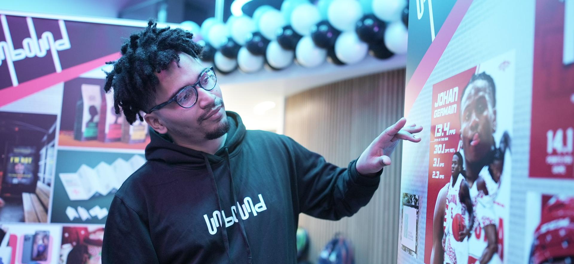 Graphic Design student explaining his projects at the graphic design show