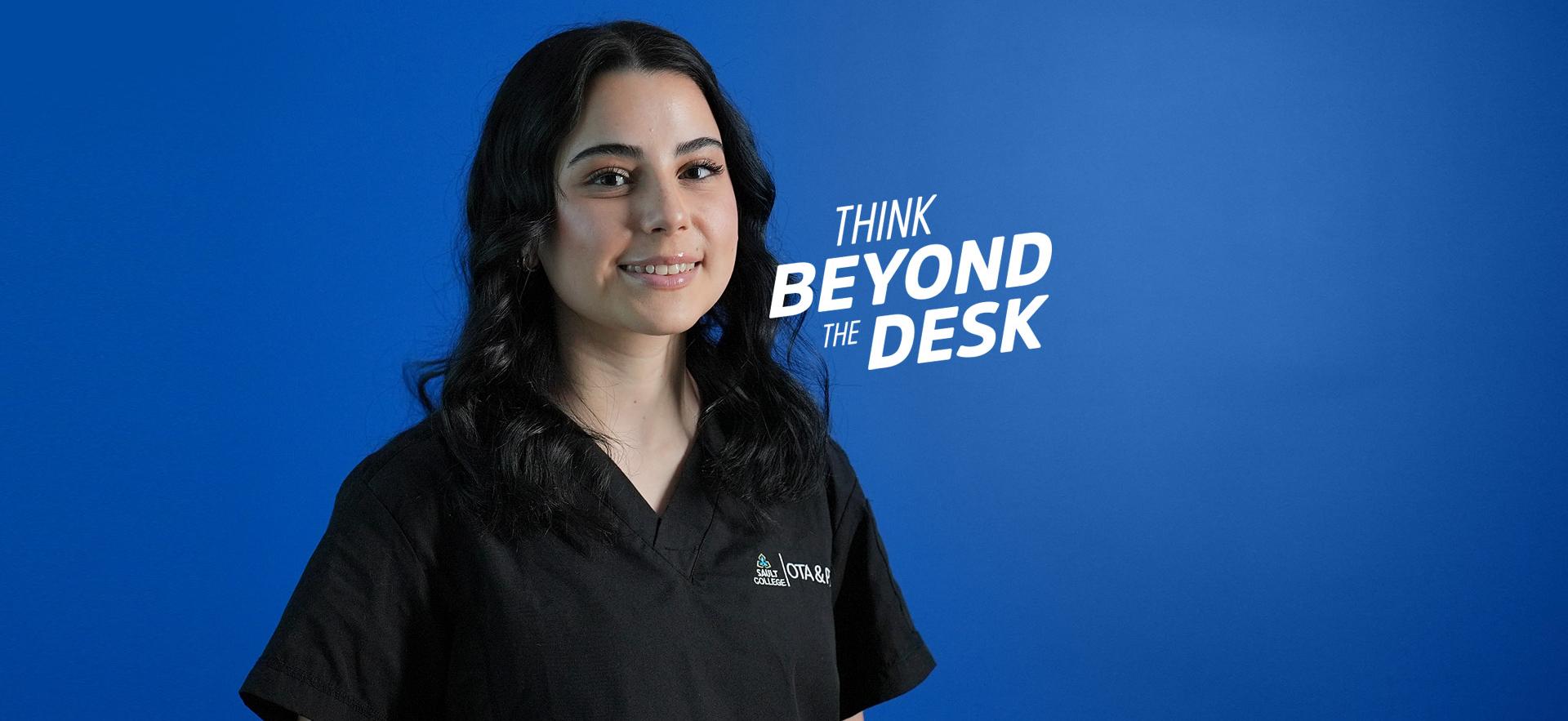 OTA & PTA student smiling at camera with blue background and think beyond the desk