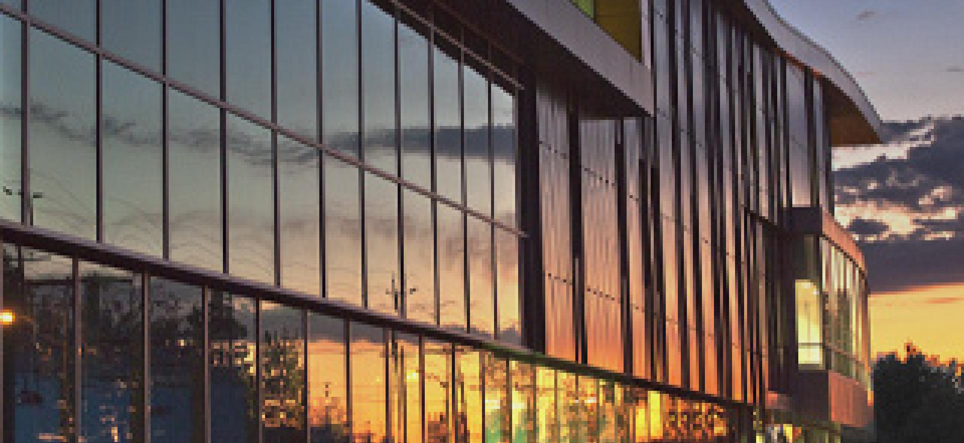 Sault College building with view of sky at sunset with Become involved with a program advisory committee text