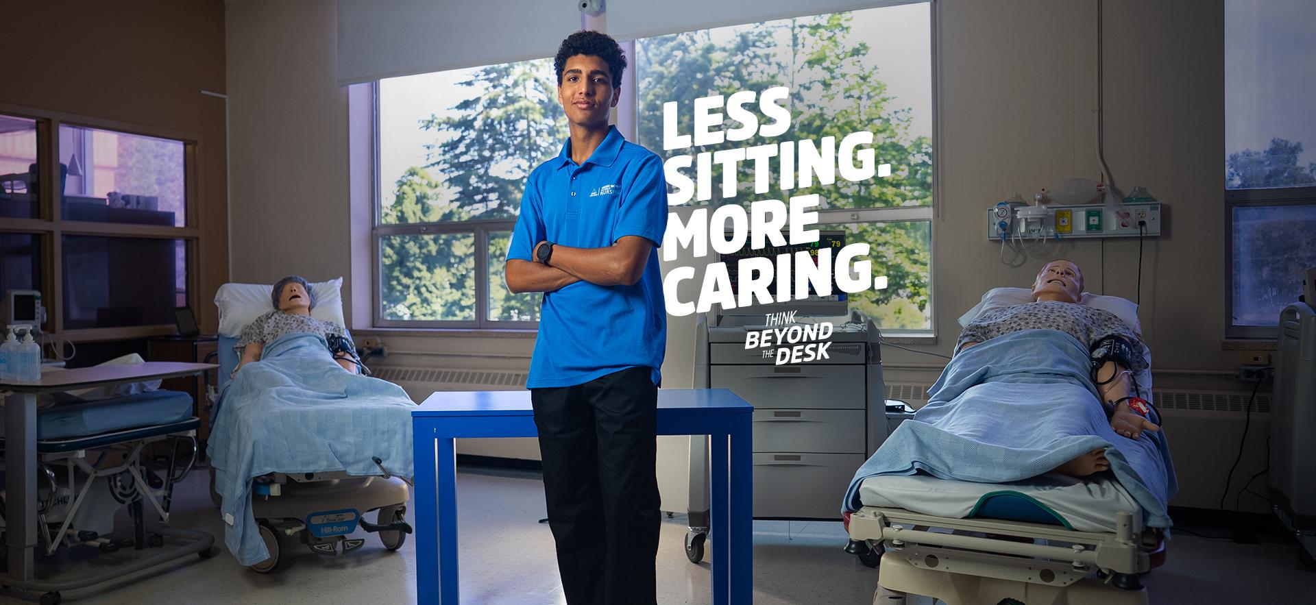 Nursing student standing in front of blue desk in the nursing simulation lab