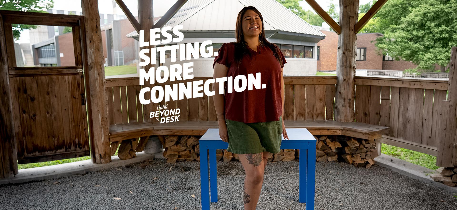 Indigenous student leaning on the blue desk in the fire arbour