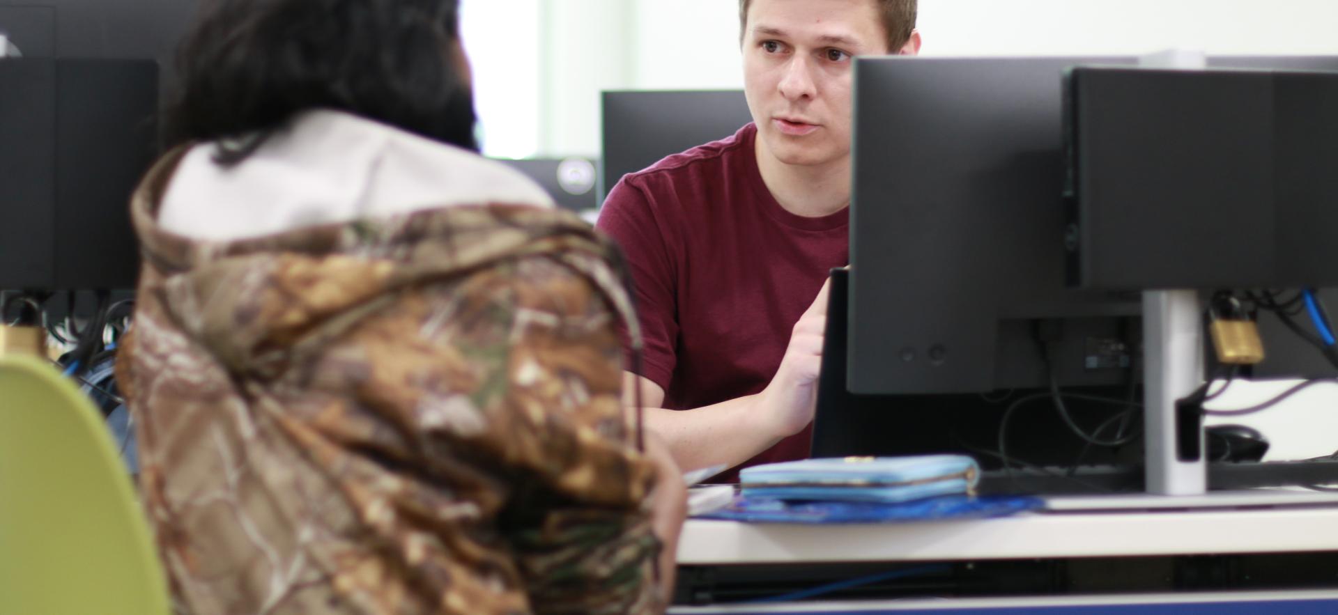 Business - Accounting student helping student during Tax Clinic