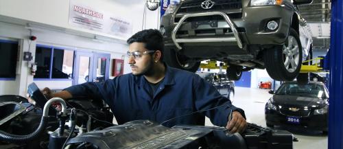 One male Automotive Service Technician student executes some diagnostic tests on an engine.                                                              