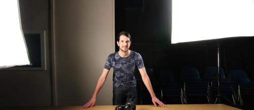 A Community Integration Through Cooperative Education student poses in the digital video studio.
