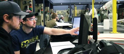 Sault College engineering students observe the technical performance of their robots in class.