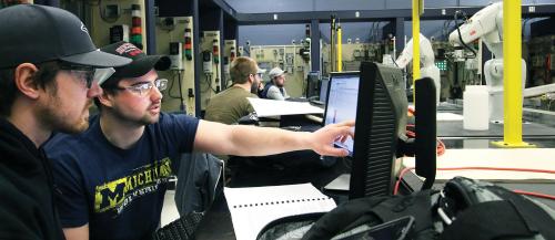 Sault College engineering students observe the technical performance of their robots in class.