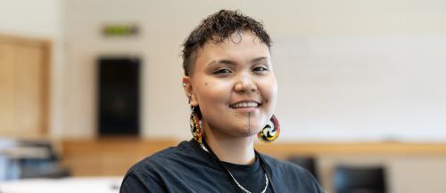 Indigenous Studies student sitting and smiling at the camera